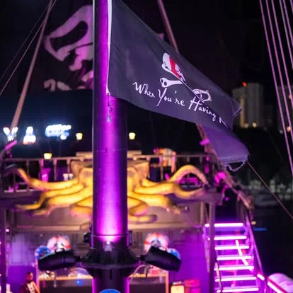 The Black Pearl deck lit up with party lights at night